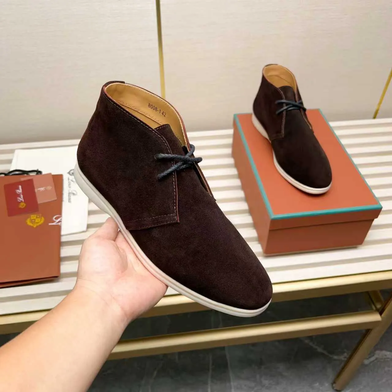 Men's Shoes 💰420 Loro Piana reimagines the desert boot—a modern, comfortable interpretation of a classic 1940s style. Crafted from suede calfskin, it exudes elegance. The tight texture of suede calfskin is not only durable but also looks casual and sophisticated. Add a timeless piece to your shoe collection, harmoniously blending comfort, style and Loro Piana's heritage of craftsmanship. Acetate satin detail on the inside White sole with LP lettering for added traction Space for a personalized signature on the heel Tonal suede trim Upper: 100% cow split suede Sole: 100% Rubber lining: Cow leather